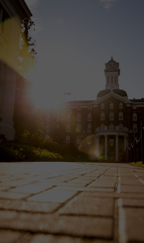 sun shines aside Old Main clock tower