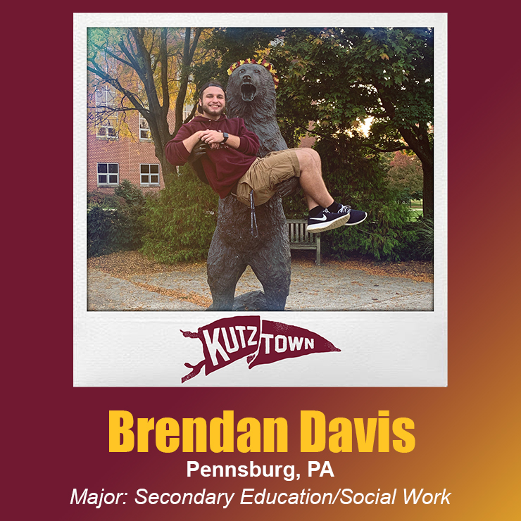 Brendan Davis grinning in the arms of the roaring bear statue, with his name and majors, secondary education and social work, listed below his picture 