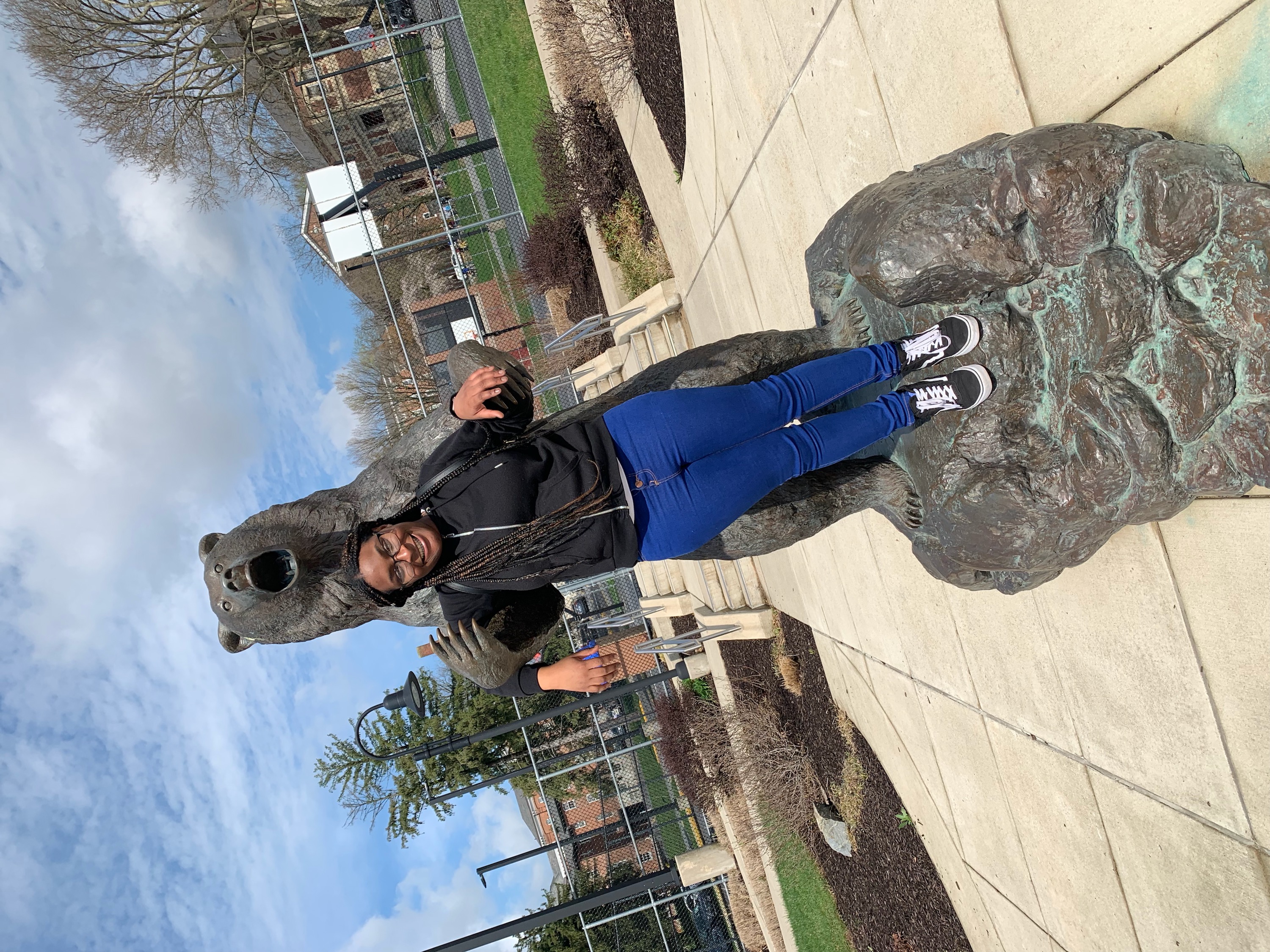 Deborah McKyer posing with the bear statue 