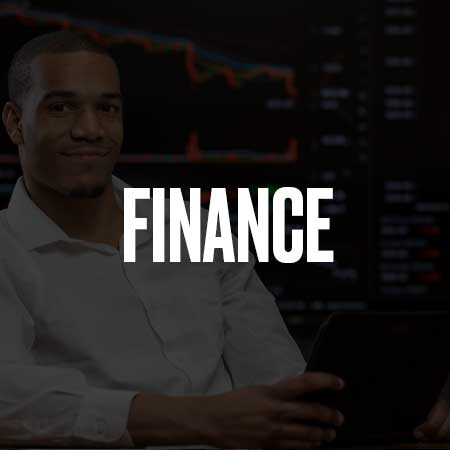 An image of a man with a tablet sitting in front of a screen with stocks on them and the word finance on top of it