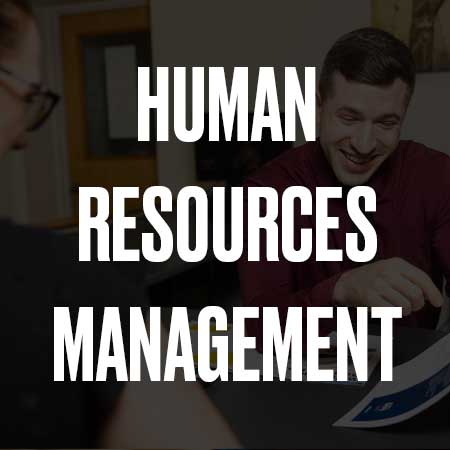 Image of a male showing a female a piece of paper with the word human resources management on top of it