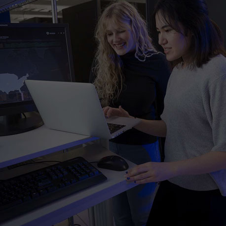 Two females at a computer working