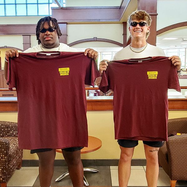 KU freshman holding up their Amazing Academic Race t-shirts.