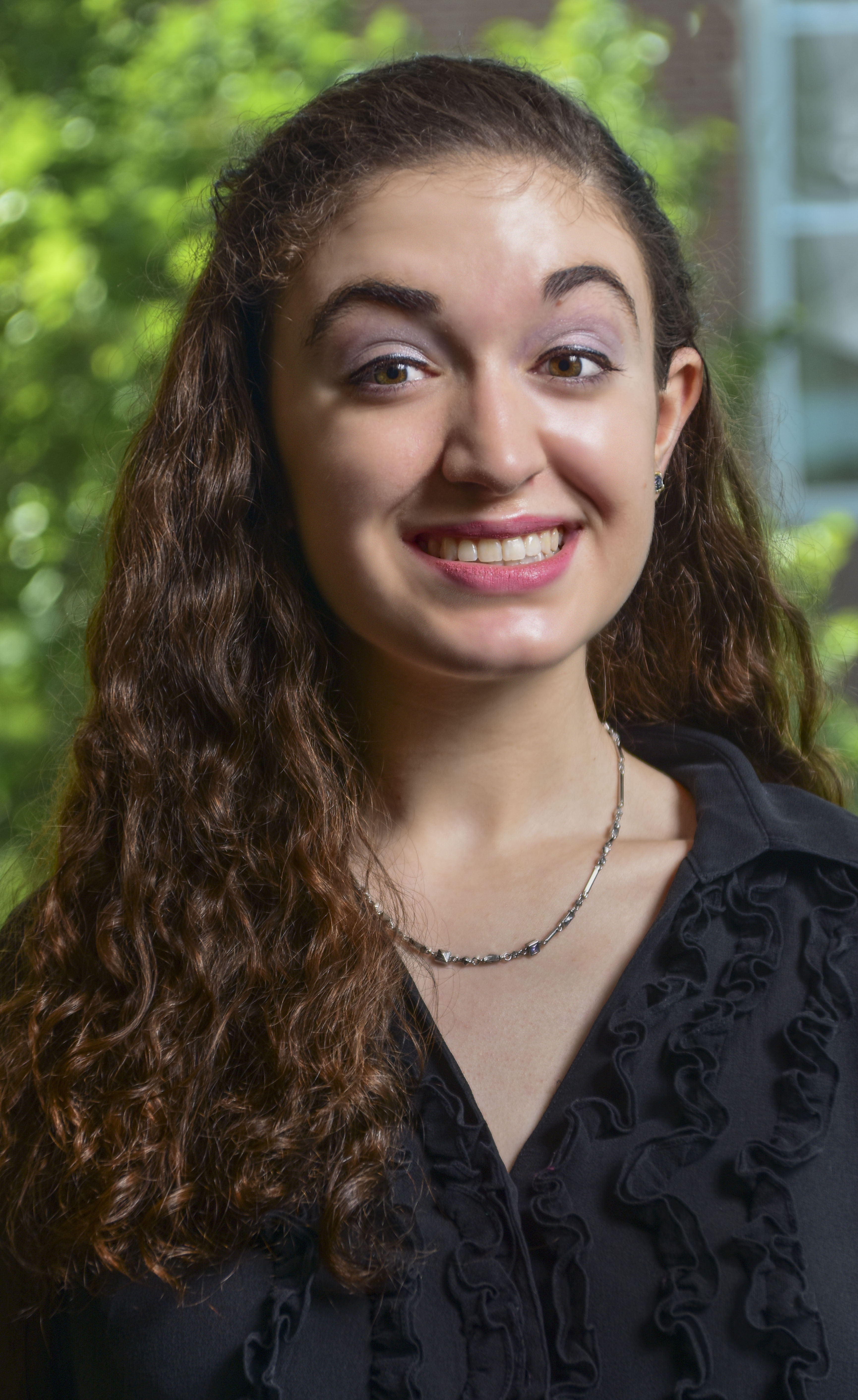 Vanessa Haybruck headshot outside, in front of a tree 