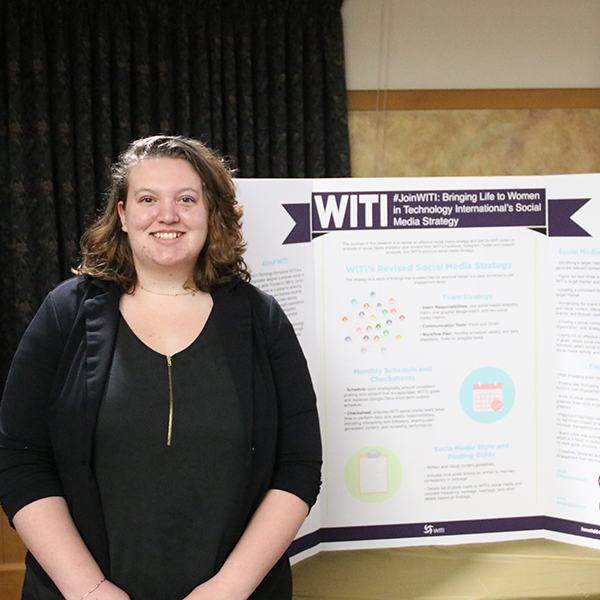 Student in front of a poster presentation titled "#Join WITI: Bringing life to women in Technology International's social media strategy."  