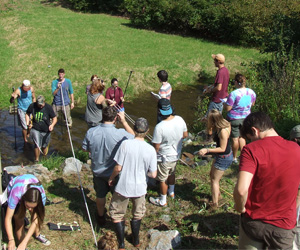 many students working in a stream bed