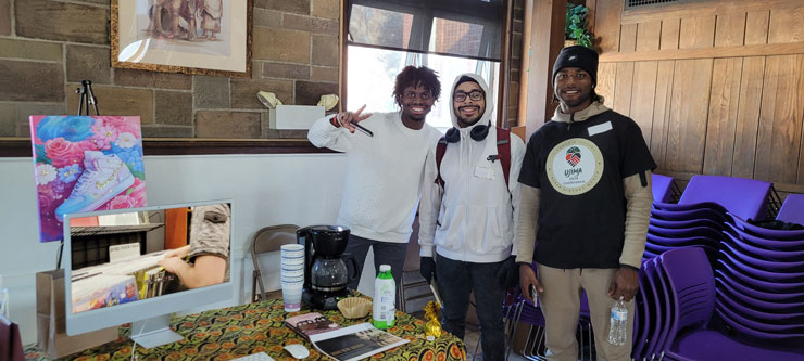 Three students pose for a photo at the Black Literature, Media and the Arts Event. 