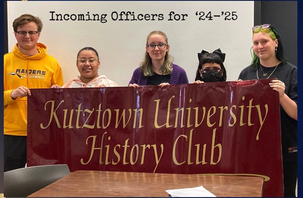 Incoming History Club officers standing in a row holding the KU history club banner