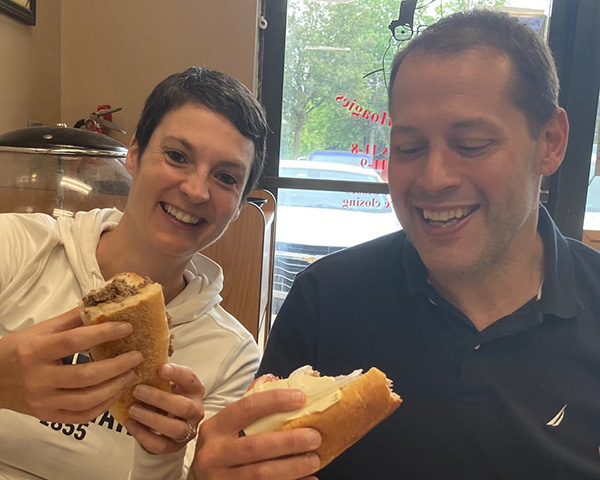 Vaneesa Cook eating a cheesesteak with her husband