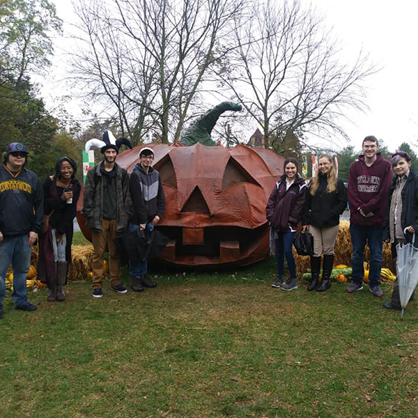 History club students with a giant metal pumpkin
