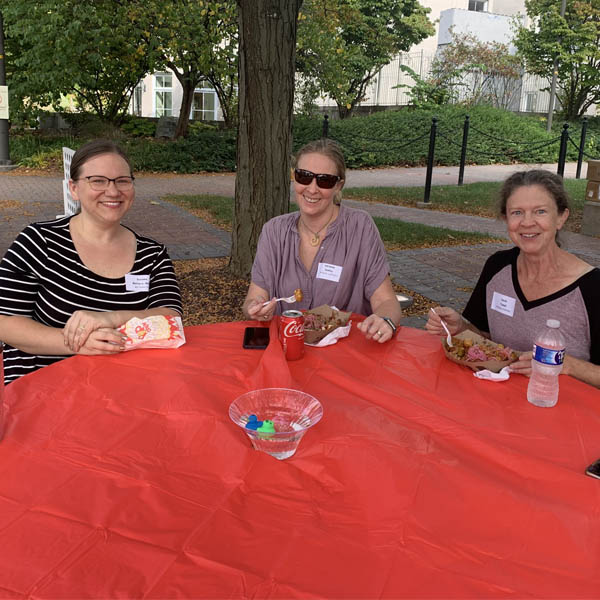 Faculty at a table enjoying each other's company.