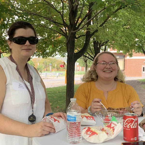 Staff at a table enjoying each other's company.