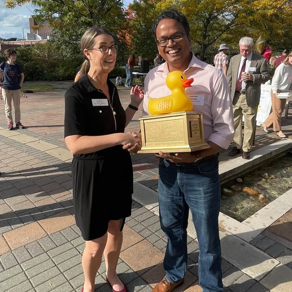 Dean and Department Chair of Physics holding Winning Duck Award