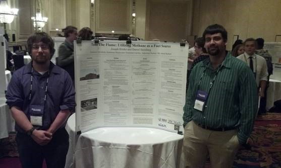 Students posing in front of their poster