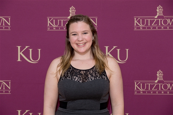 Shannon Golden standing in front of KU wallpaper 