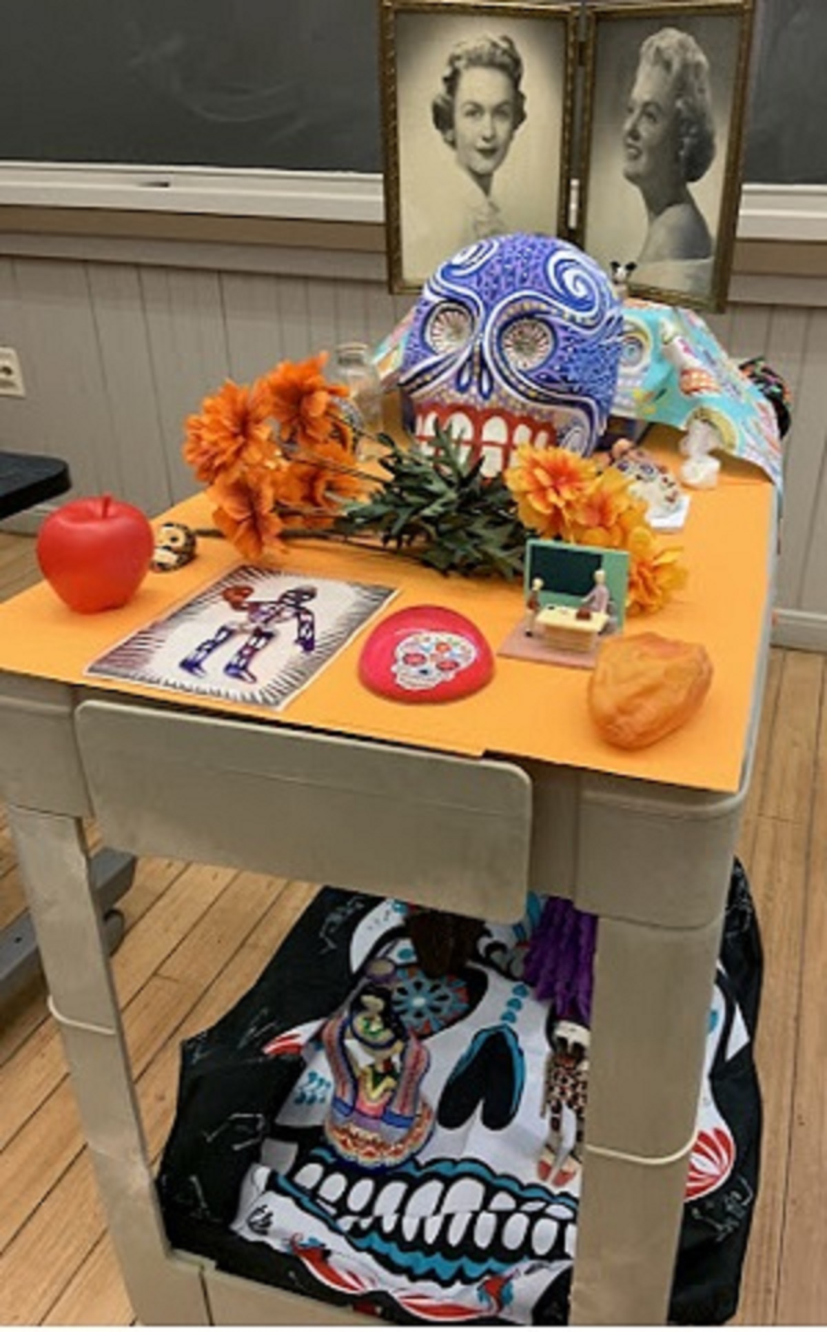 Sample day of the dead altar decorated with sugar skulls, fake flowers and plastic fruit 