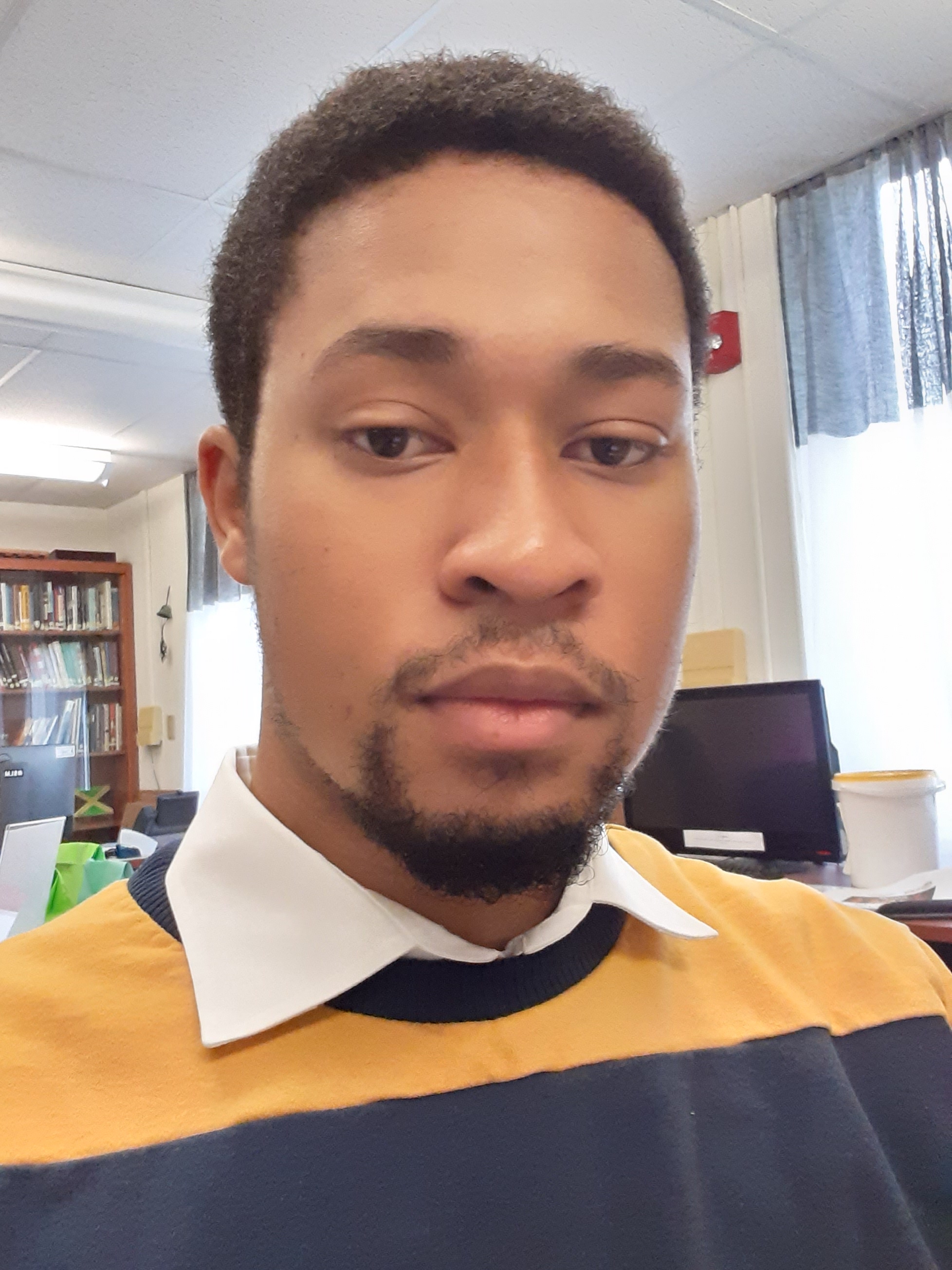 man wearing blue and yellow shirt in multicultural center