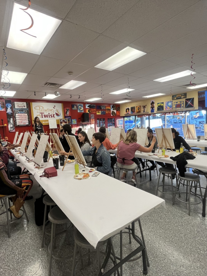 group of students in white room painting