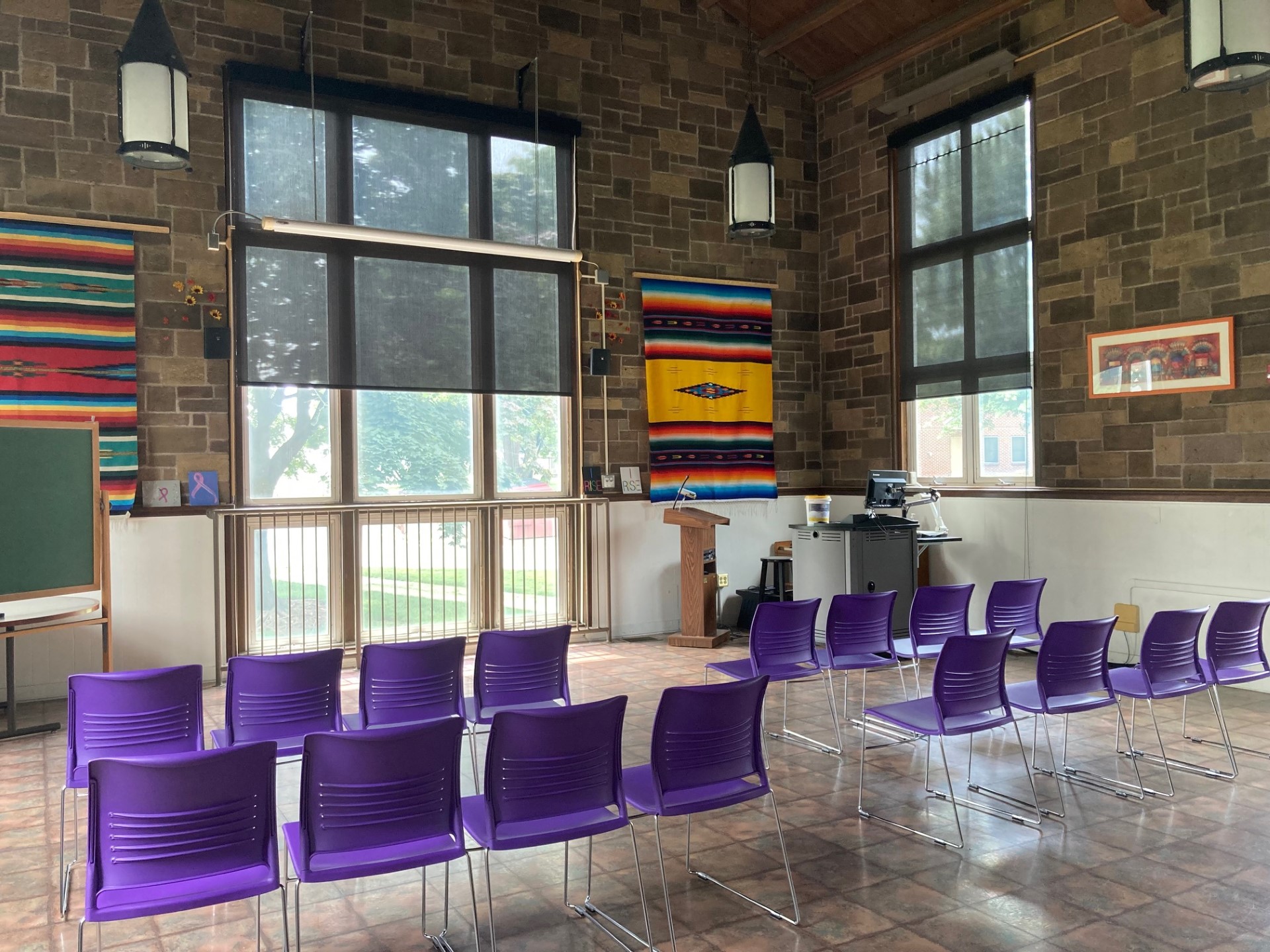 purple chairs in high-ceilinged room with natural light