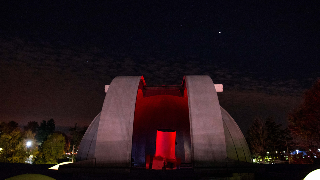 Exterior view of dome and telescope at night