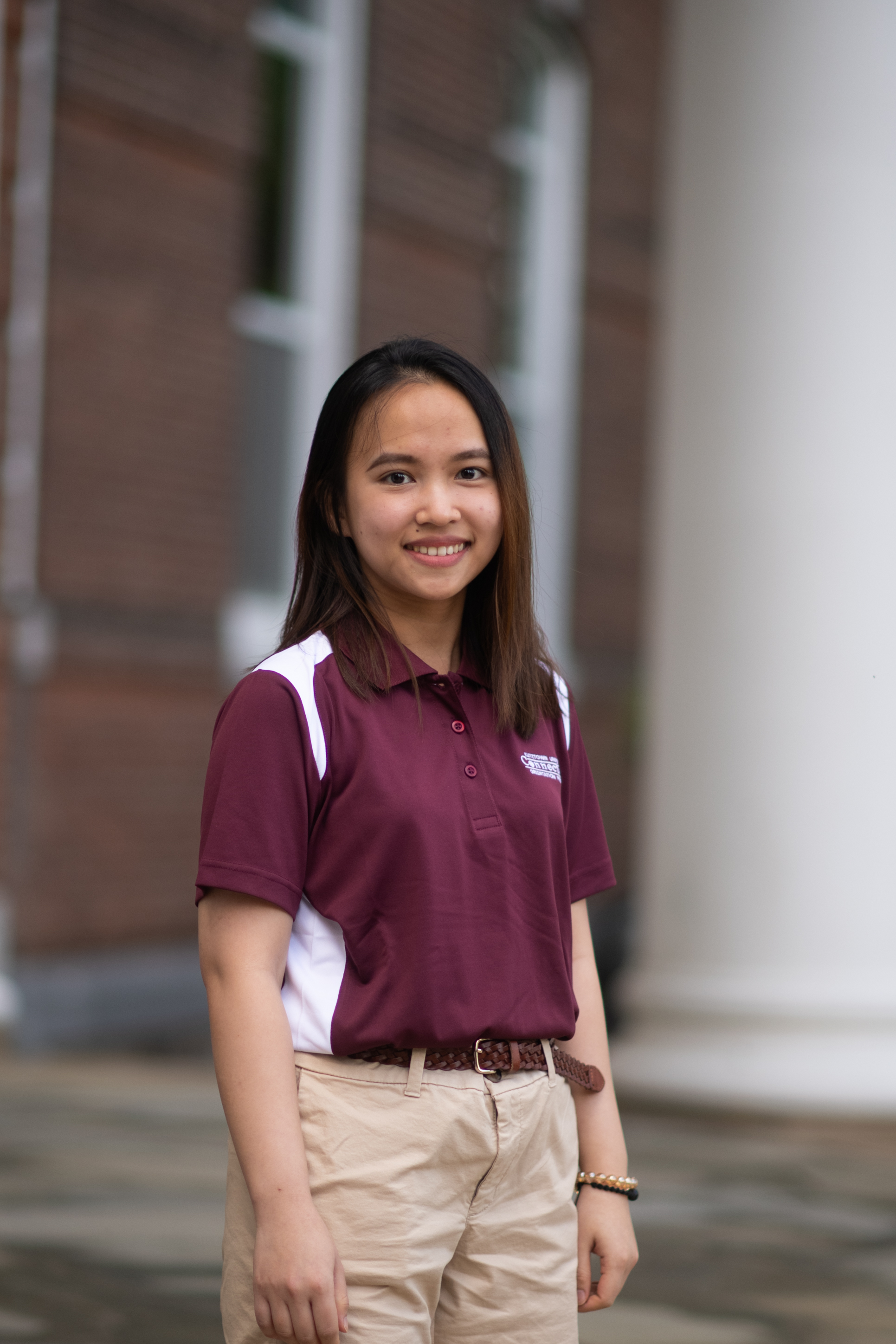 female student Van Ahn Thi Nguyen smiling in front of Old Main