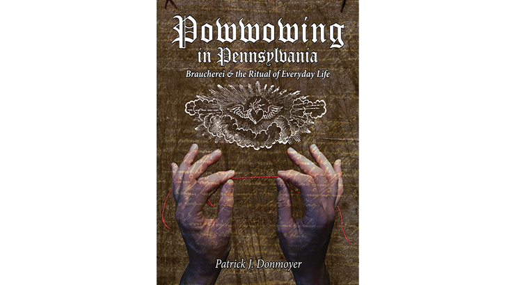 Front Cover: Two hands are holding a red string between the pointer finger and thumb. above is an etching of a bird in a cloud. The title is above that, and reads, "Powwowing in Pennsylvania: Braucherei & the Ritual of Everyday Life"