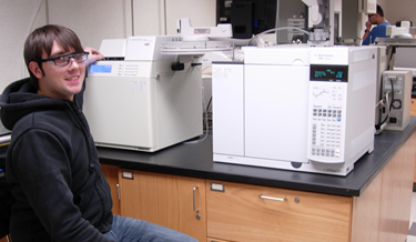 Student in front of the Agilent 7890A gas chromatograph