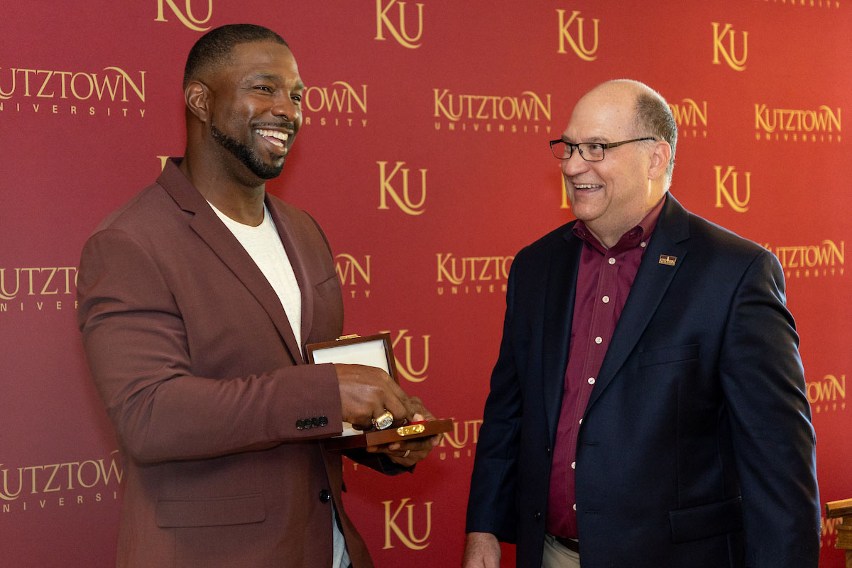 Mobley and Hawkinson react after presentation of president's medal