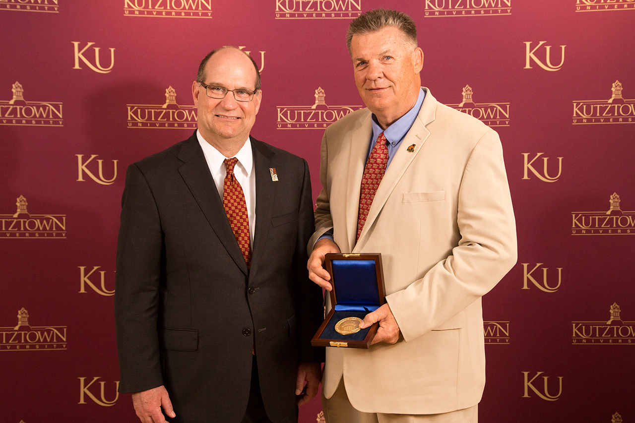 Dr. Kenneth Hawkinson (left) presenting presenting Dr. Gregory A. Jones (right) with the Kutztown University President's Medal
