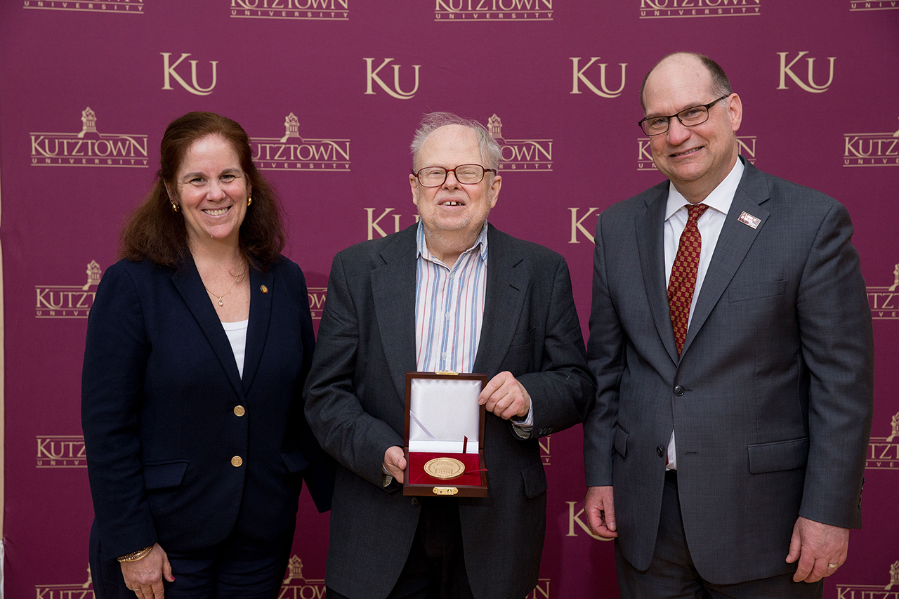 Dr. Anne Zayaitz (left) and Dr. Kenneth S. Hawkinson (right) presenting Dr. Carlson Chambliss (center) with the Kutztown University President's Medal.