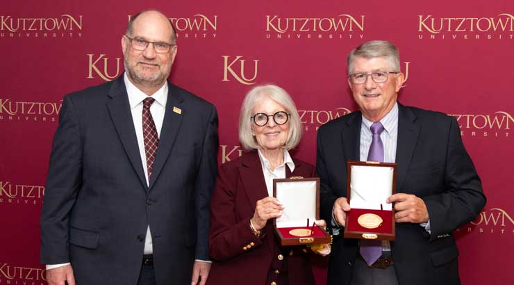 Bonita and Charles Perkins receives president's medals from President Hawkinson.