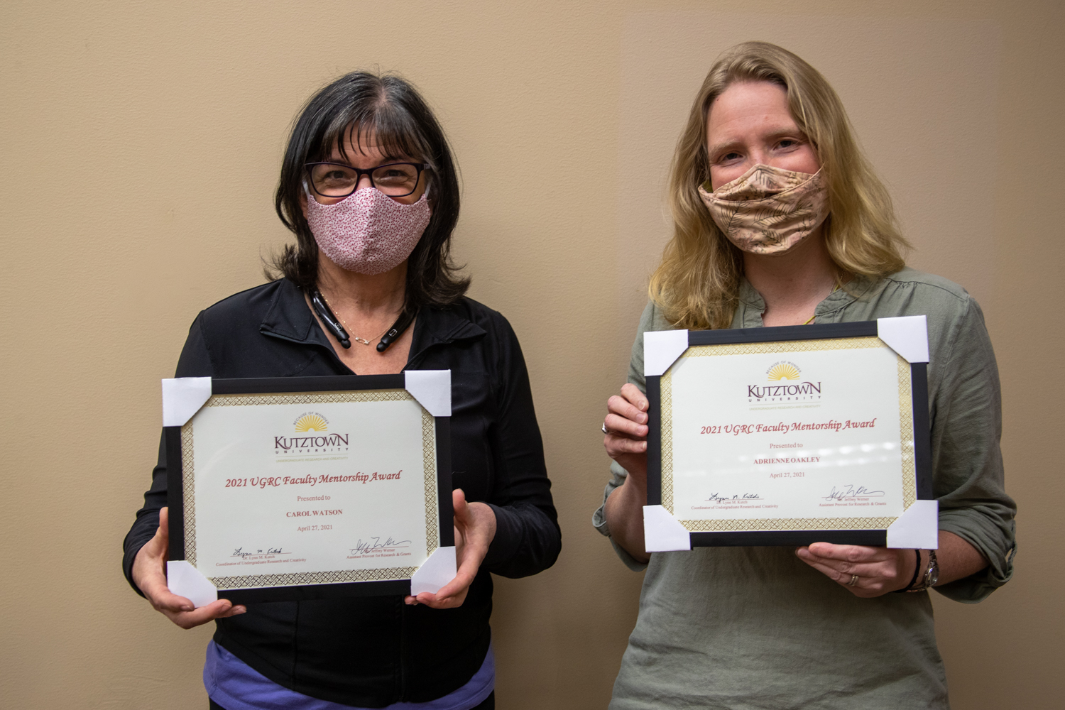 Dr. Carol Haney-Watson and Dr. Adrienne Oakley pose with their certificates.