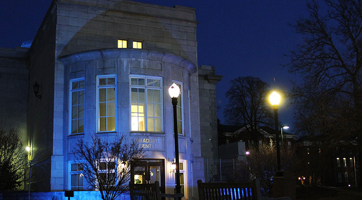 Graduate Center entrance at night, lit by bright streetlamps 