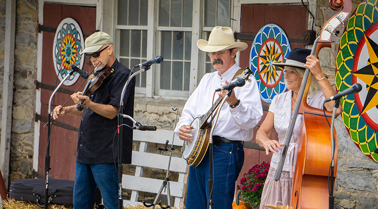 Musicians playing outside barn