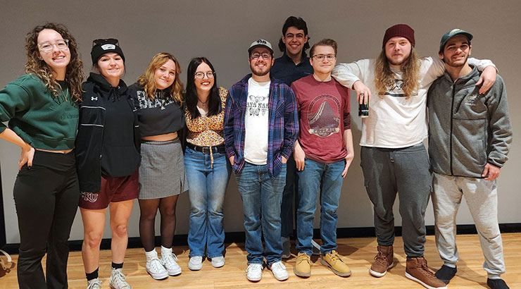 Students standing in a line, posing for photo.