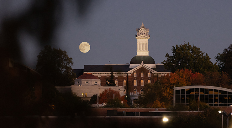 Moon over Old Main at night