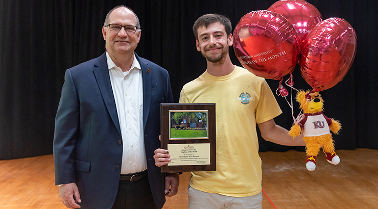 President on left presenting award to Richman on right.