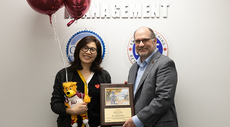 Kim presented awards from President Hawkinson