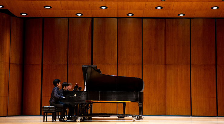 Students playing on piano.