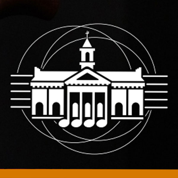 A white logo on a black background depicting the outline of the Schaeffer Auditorium Building with five white lines evenly spaced on either side and three overlapping circles behind the building graphic. A gold border bar is situated at the bottom of this graphic. 