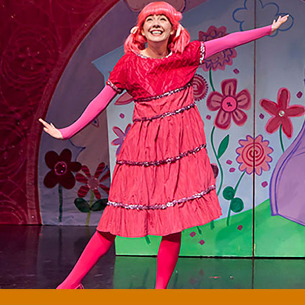 Pinkalicious smiling and dancing on stage