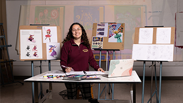 Graphic Design student exhibiting artwork in Kutztown University studio.