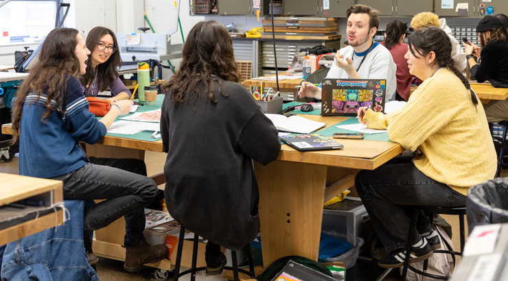 Students within graphic design major collaborating on project in Sharadin Arts Building.