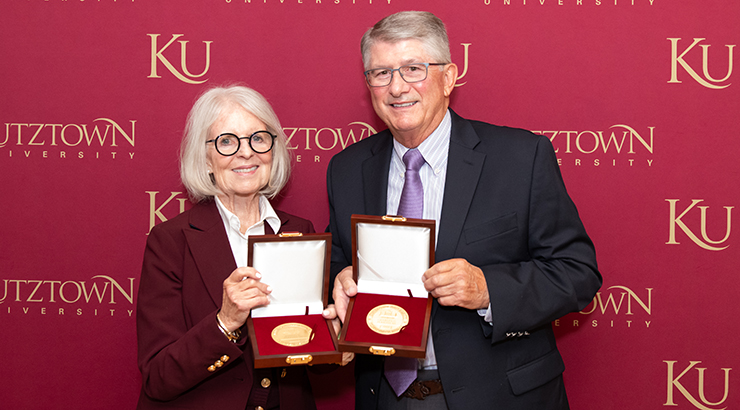 Bonita and Charlie Perkins, holding President's Medals