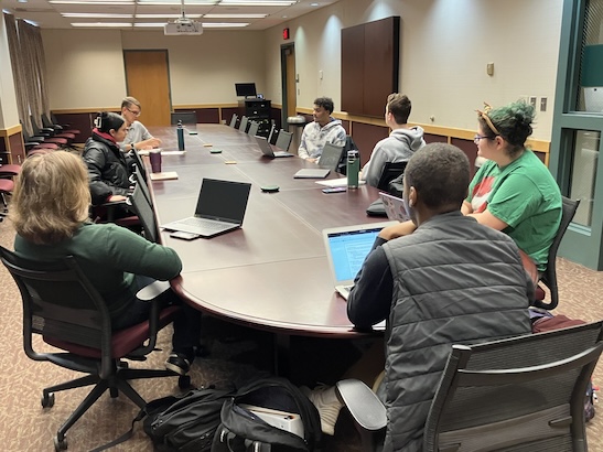 English Professor leads discussion in conference room