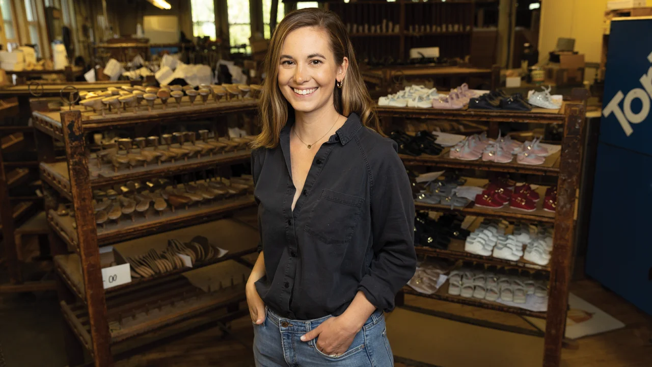 Audrey Zimmerman stands in front of racks of shoes in her family business.