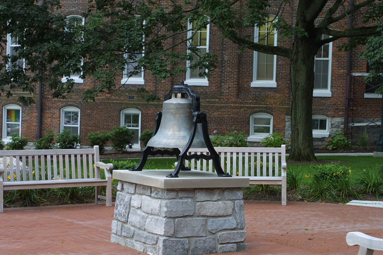 Large bell statue in the middle of College Hill Memorial Grove 