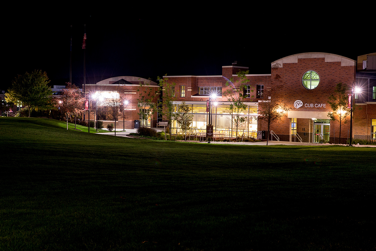 Distance shot of McFarland Student Union at night, lit up by street lamps