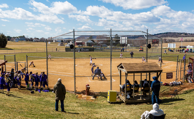 Shot of the softball field from behind home plate during a game
