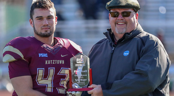 Tyler Boger and PSAC Commissioner holding PSAC champion scholarship trophy 